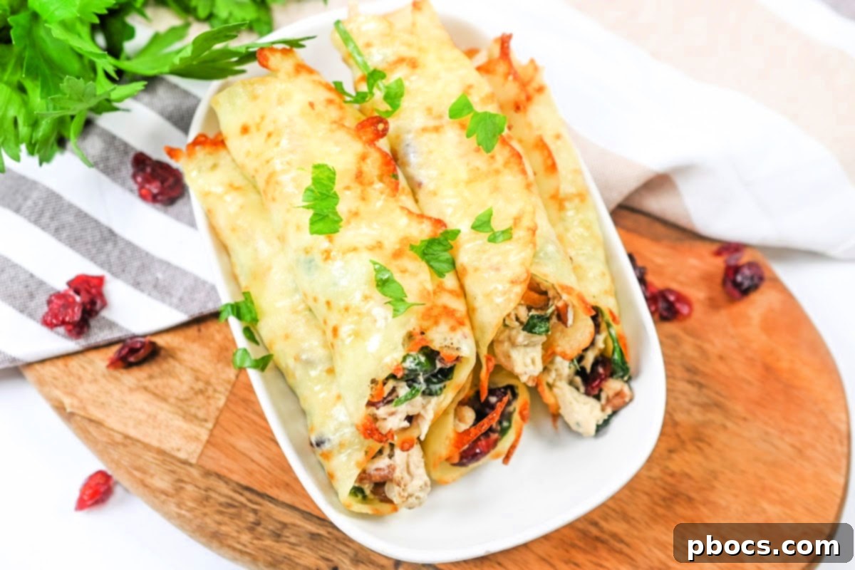 Finished cranberry pecan chicken roll-ups on a baking sheet