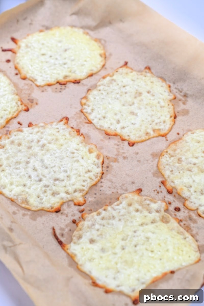 Mozzarella cheese circles baking on parchment paper