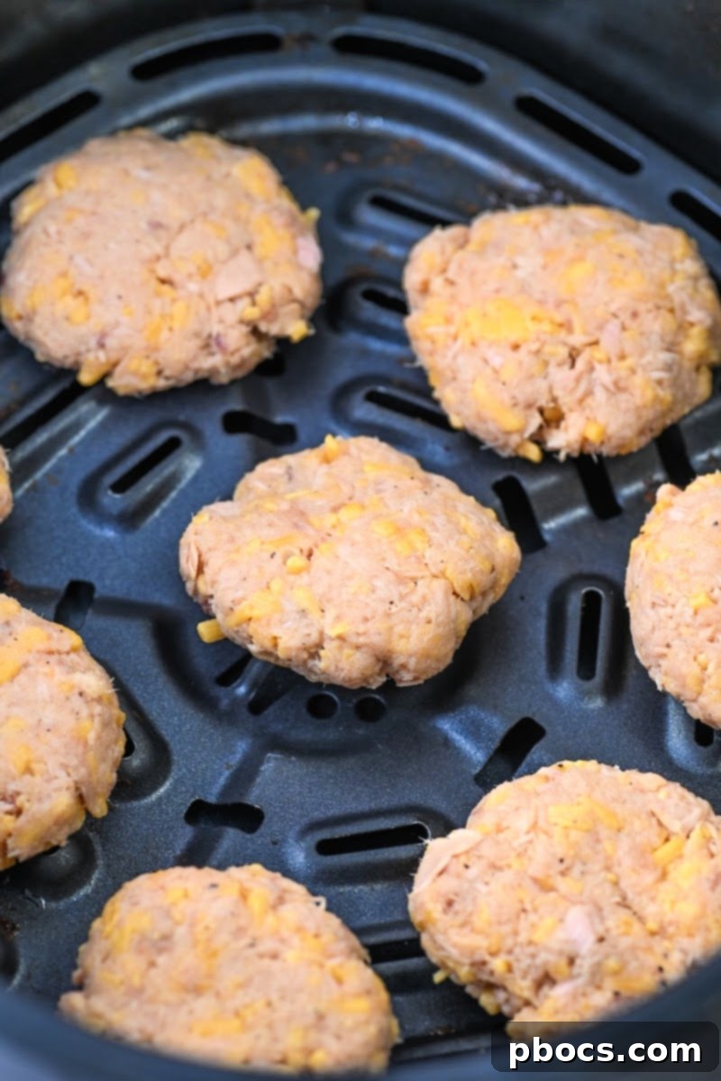 Uncooked Keto Air Fryer Tuna Bites arranged in the air fryer basket