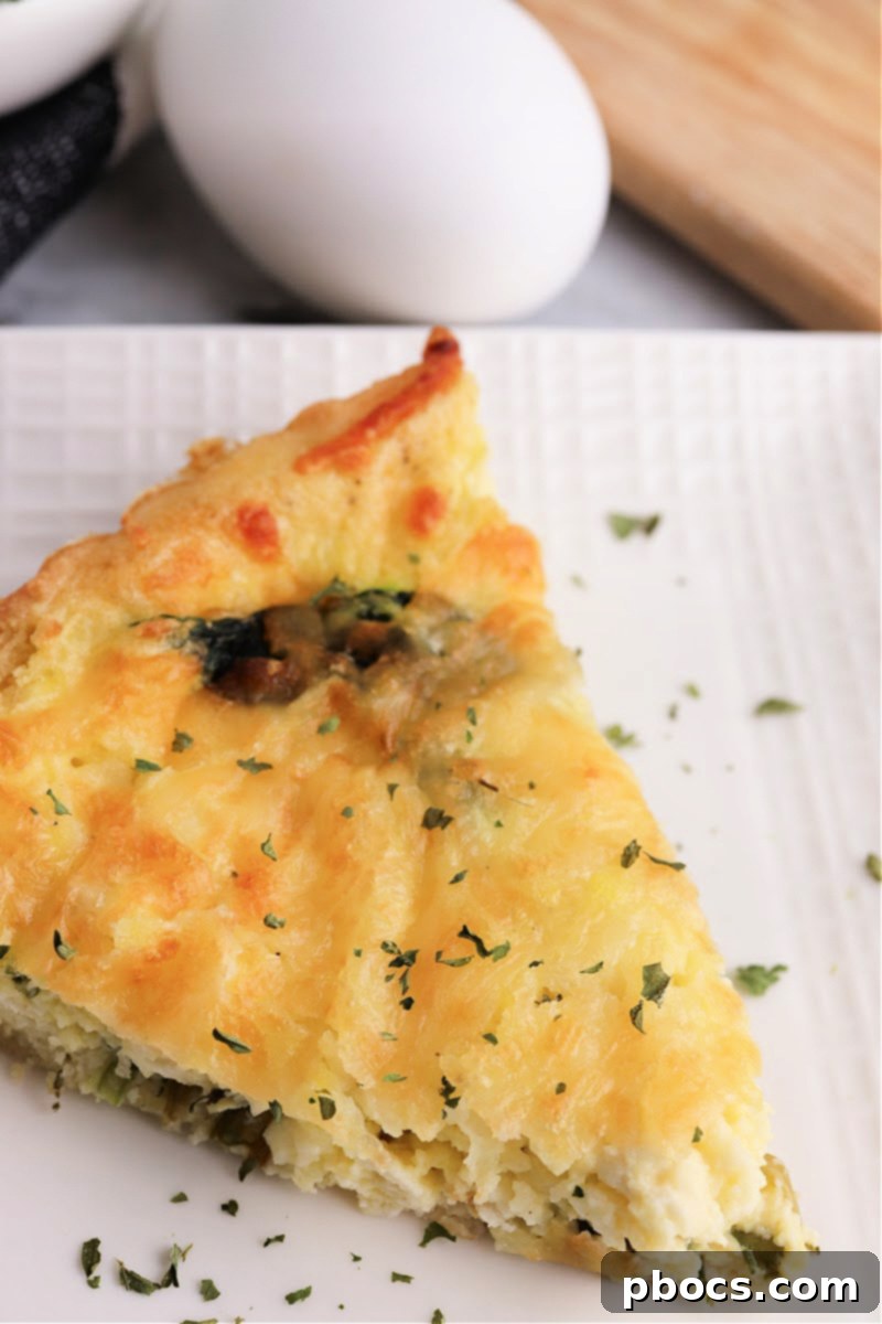 Mediterranean Keto Spinach Feta Bake 4 A vibrant slice of Keto Spinach Feta Quiche with a flaky crust.