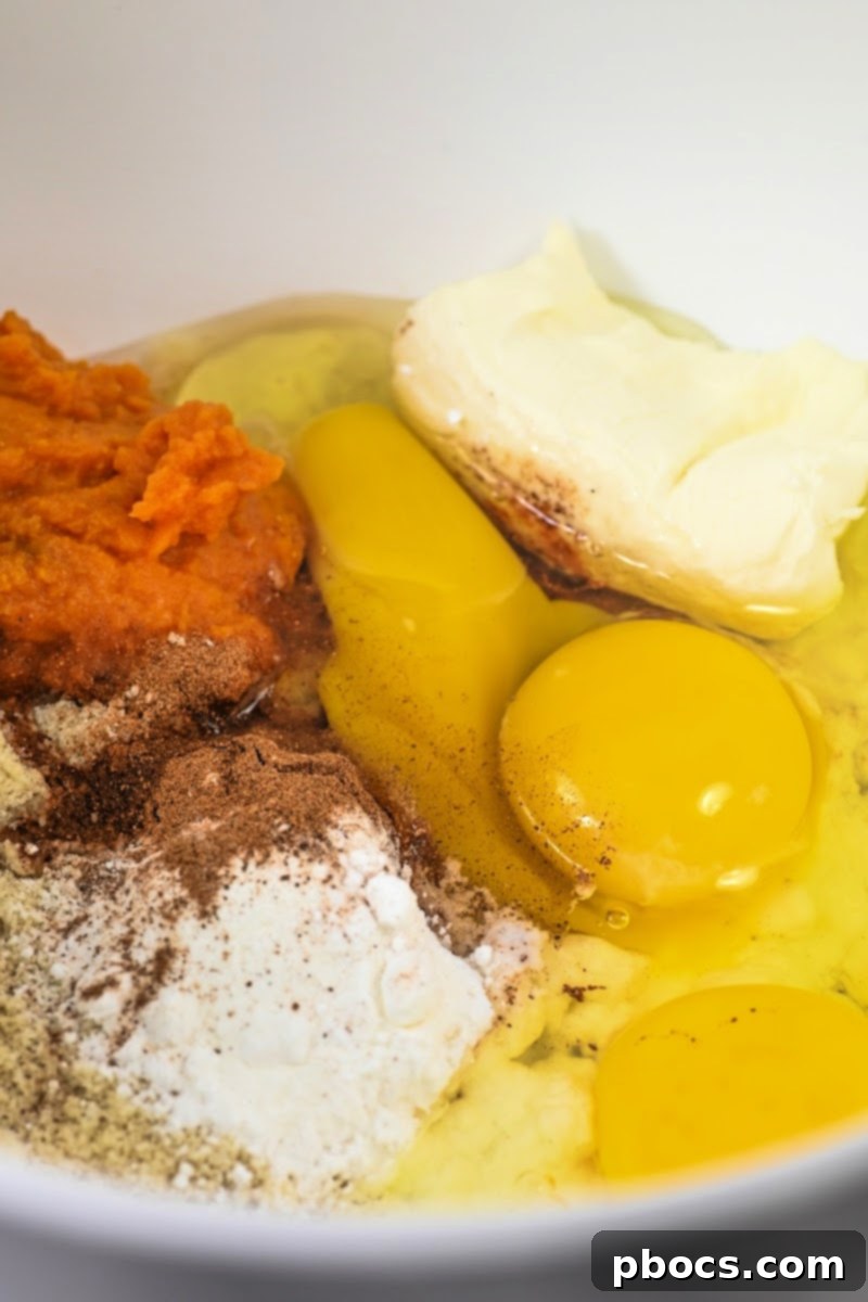 Mixing Keto Pumpkin Spice Dutch Baby batter ingredients in a bowl