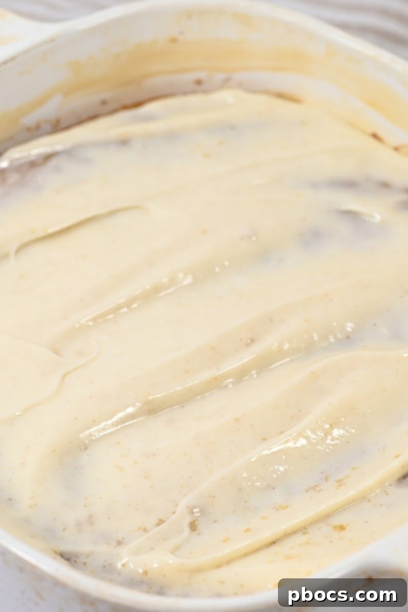 Decadent Keto Cinnamon Brown Sugar Zucchini Cake 13 Spreading cinnamon cream cheese frosting on the cooled keto zucchini cake