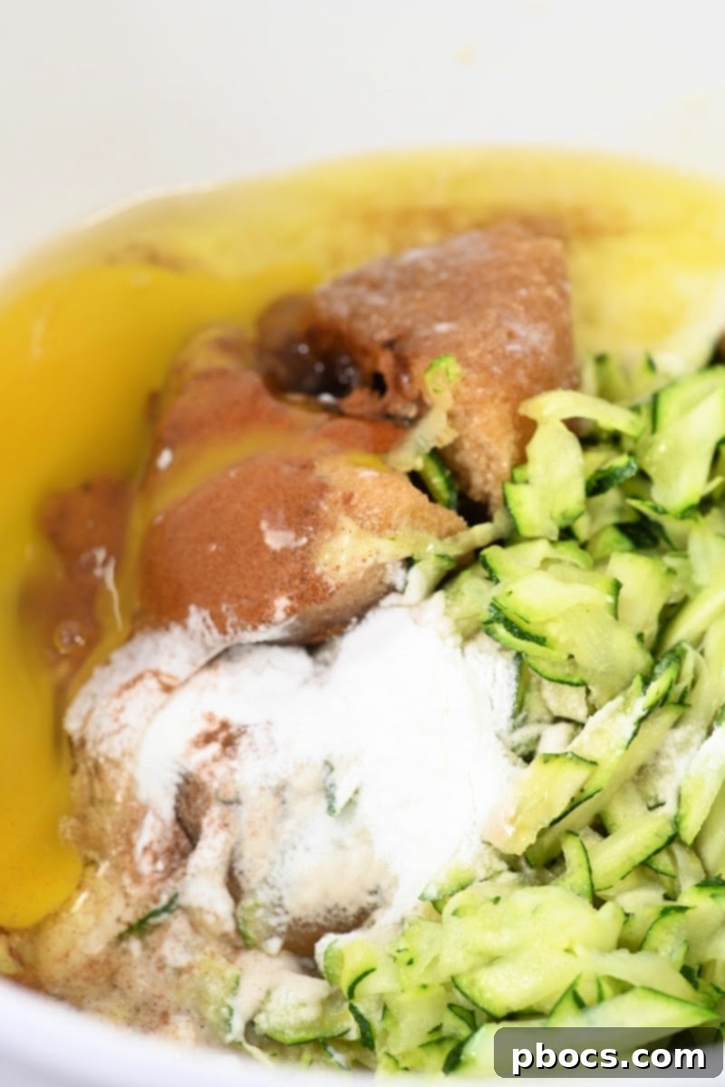 Decadent Keto Cinnamon Brown Sugar Zucchini Cake 9 Mixing cake batter ingredients in a bowl