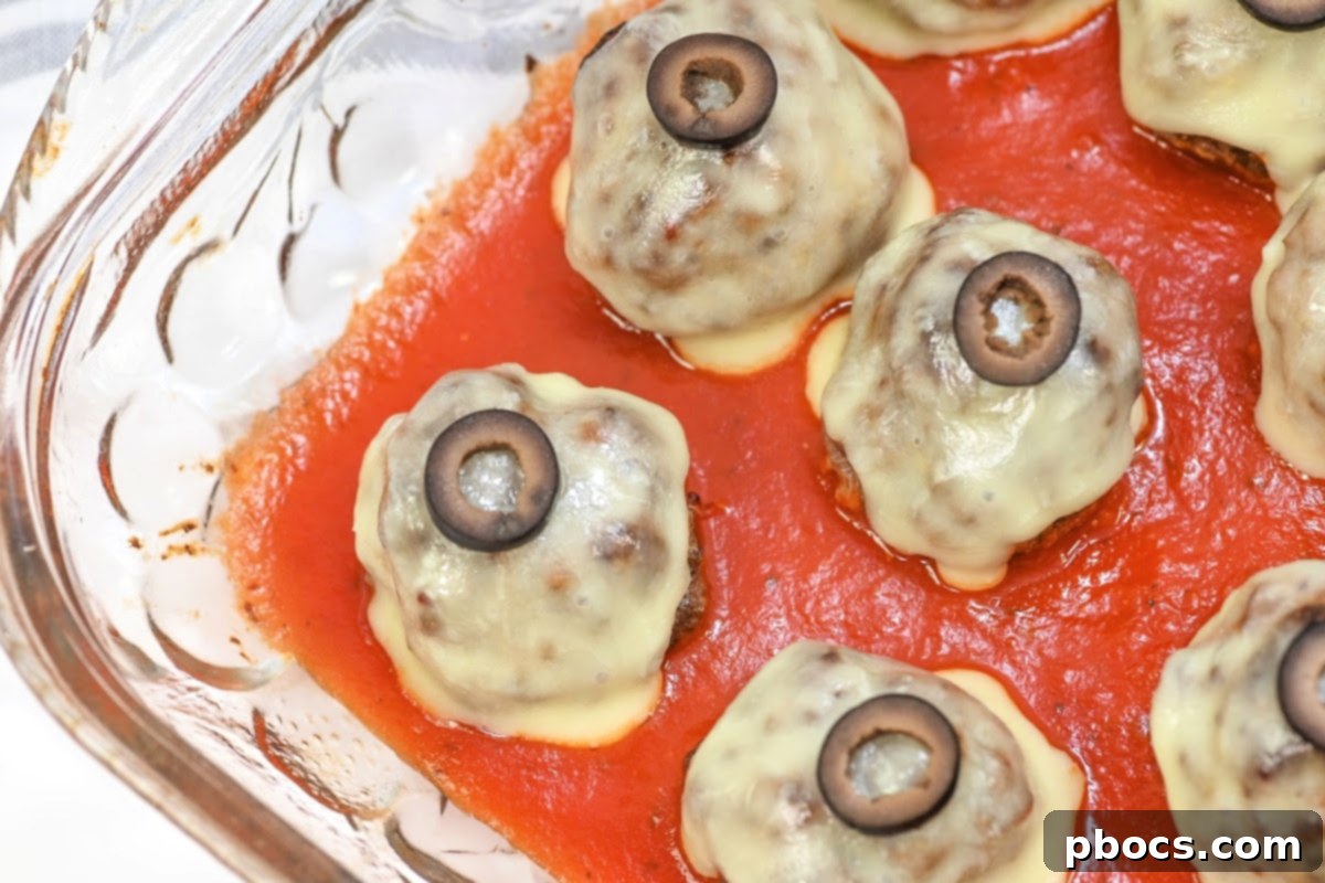 Keto Meatball Eyeballs served in a baking dish with marinara sauce, ready to eat