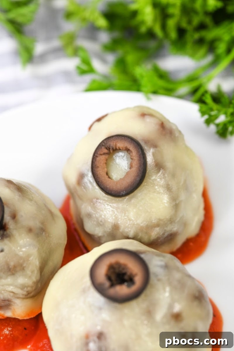 Cooked Keto Meatball Eyeballs in a glass meal prep container