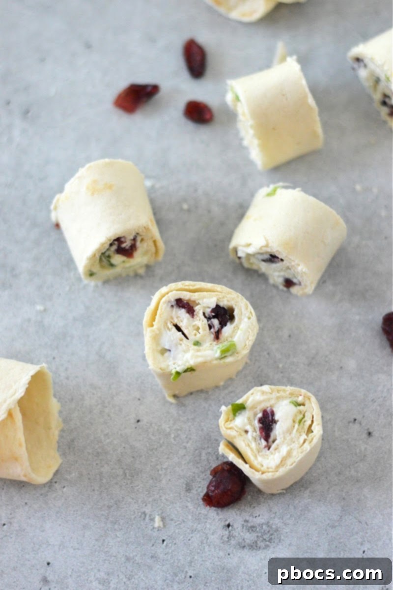 A close-up of a single Low-Carb Cranberry Cream Cheese Pinwheel, highlighting the layers.