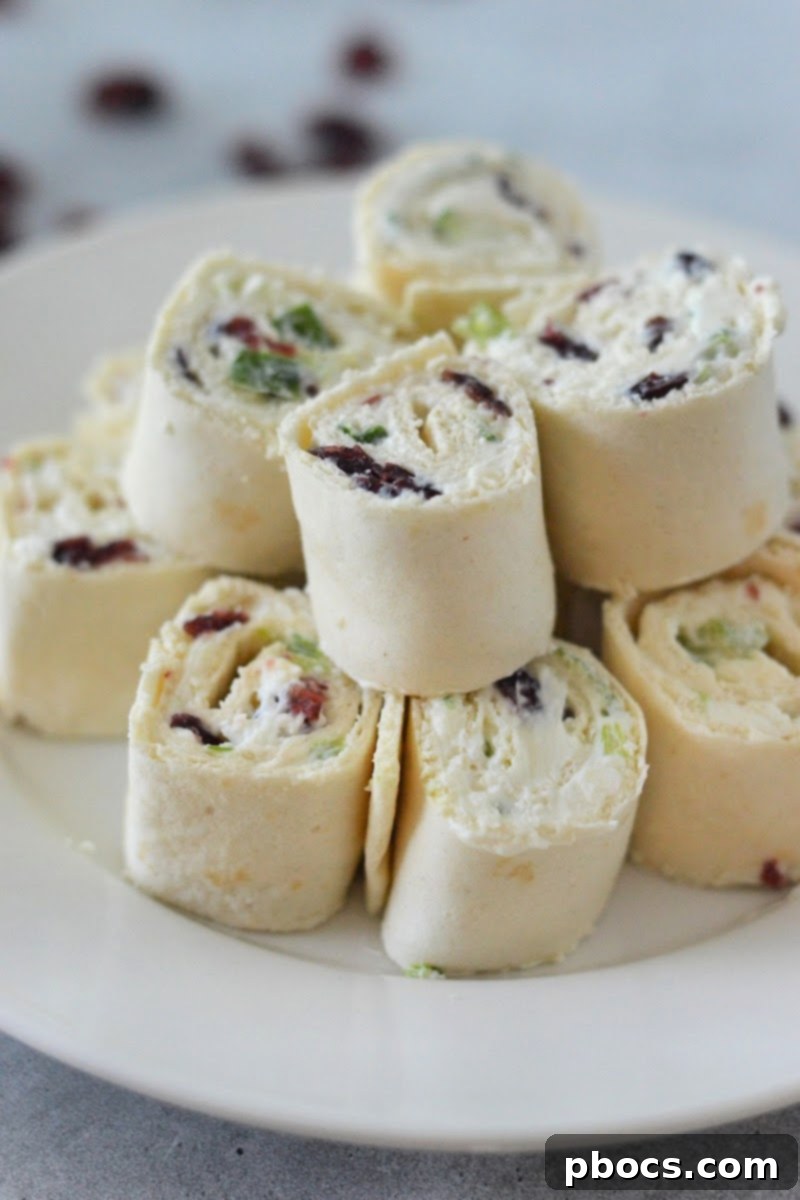 Close-up of a spread low-carb tortilla with cream cheese mixture, ready to be rolled into pinwheels.