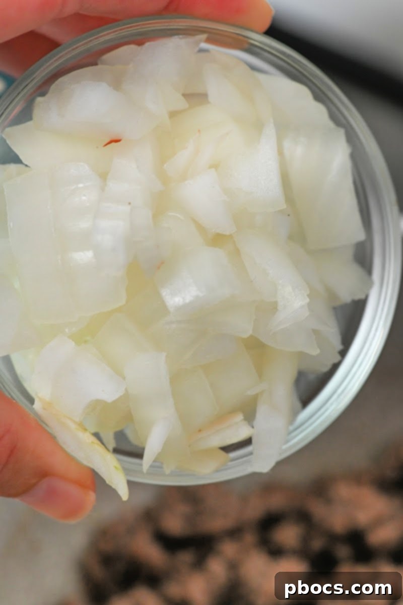 Adding diced onions to browned ground beef