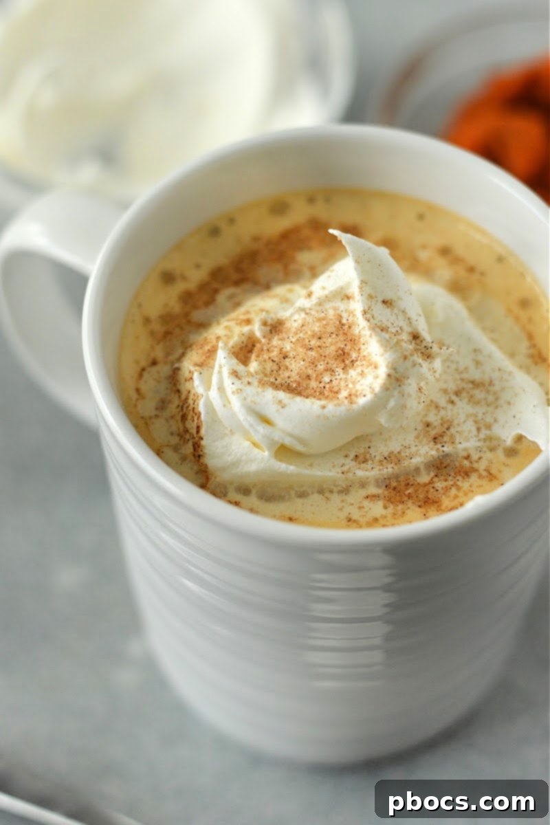 Homemade Low-Carb Pumpkin Spice Latte in a mug, garnished with whipped cream and cinnamon