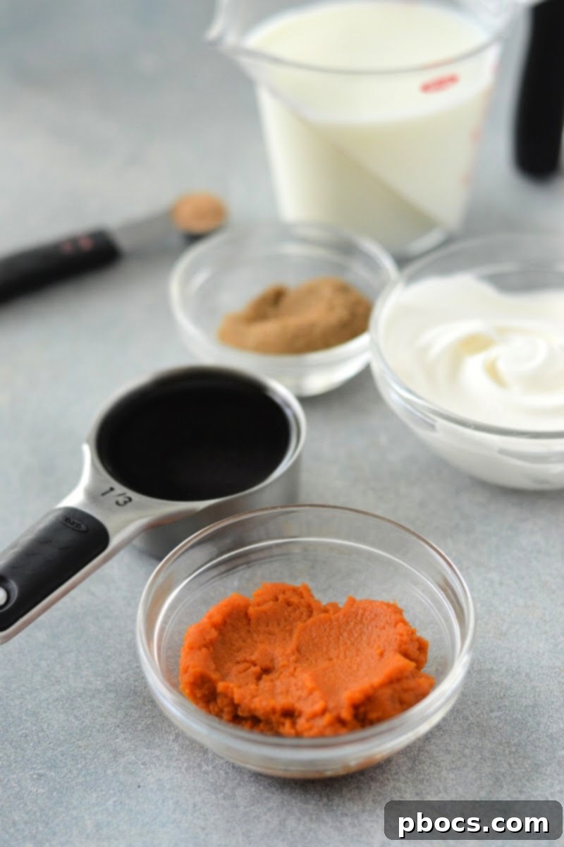 A person holding a glass of Low-Carb Pumpkin Spice Latte, showing its rich color