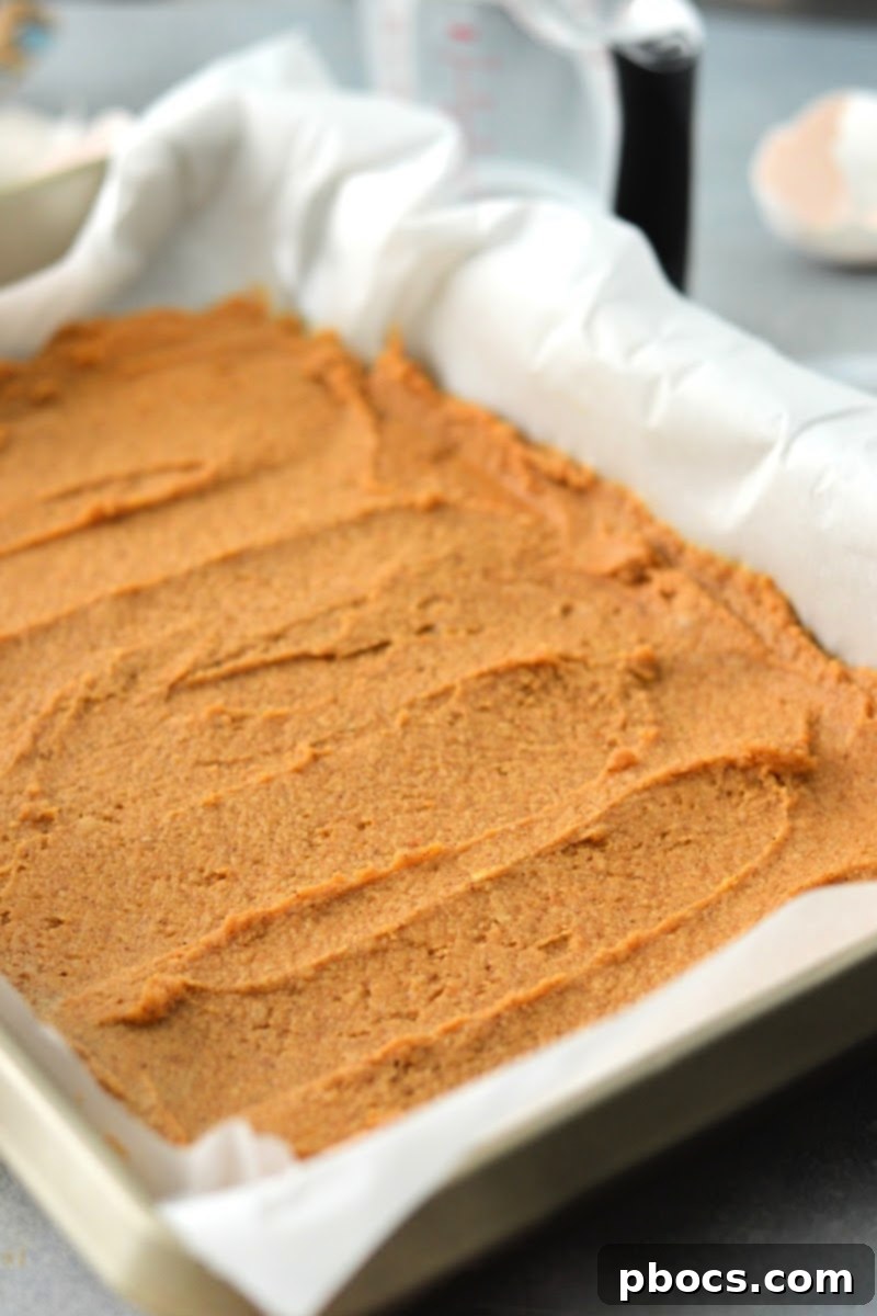 Cake batter spread evenly in a 9x12 inch baking pan