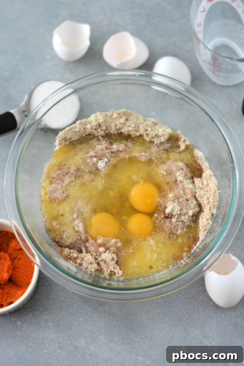 Adding wet ingredients like eggs to the dry mix