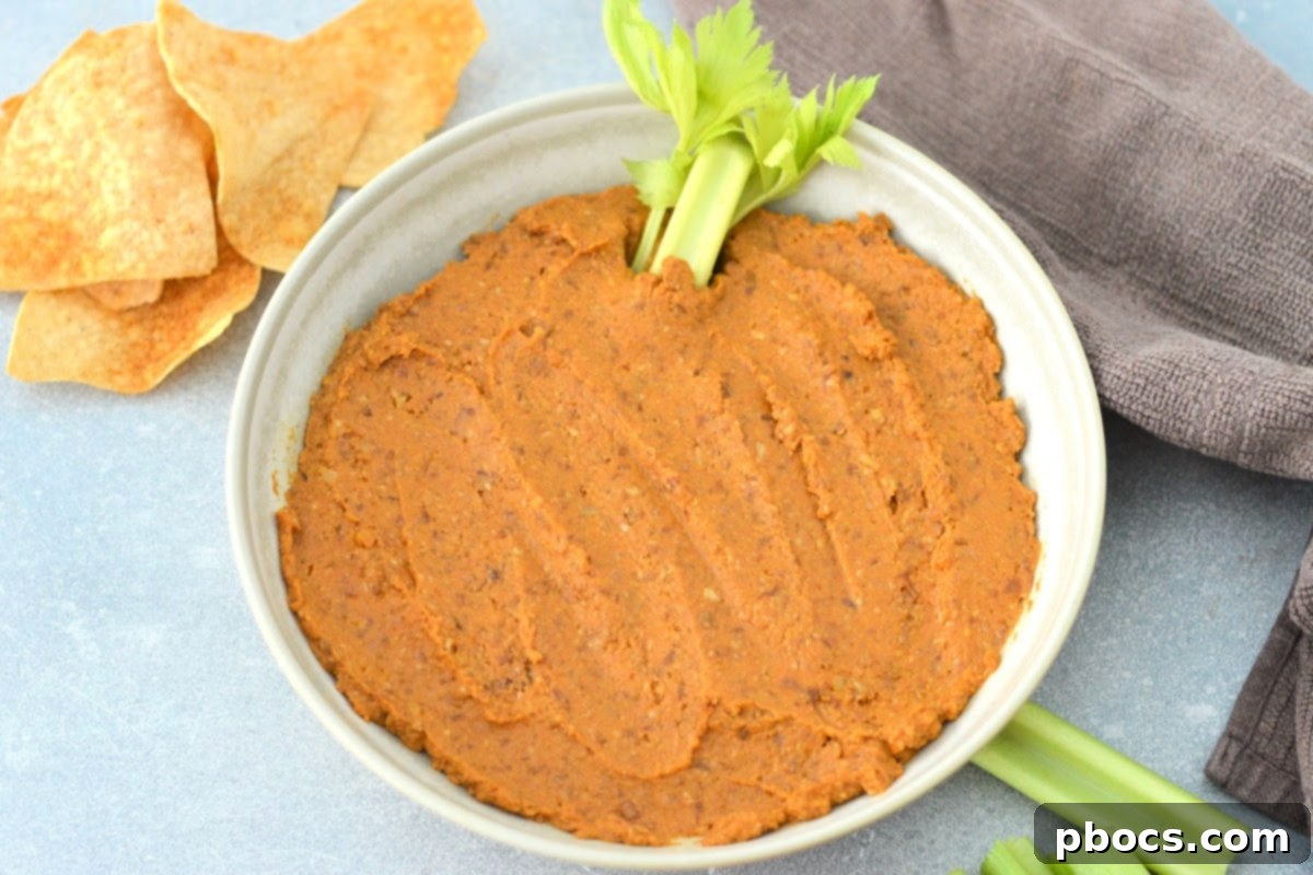 Creamy Keto Pumpkin Veggie Dip 10 Keto Pumpkin Veggie Dip garnished with a celery stick
