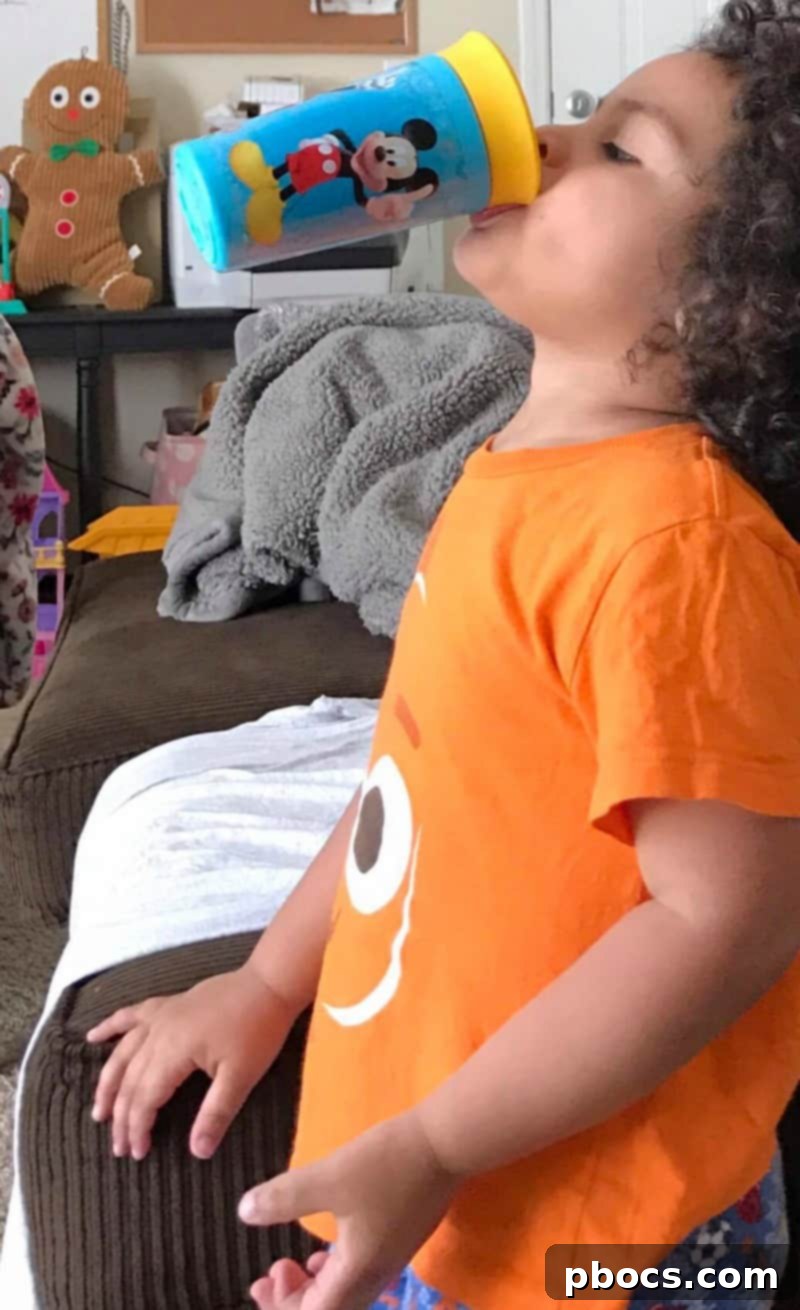 Child drinking from TOMY Mickey Mouse Sippy Cup