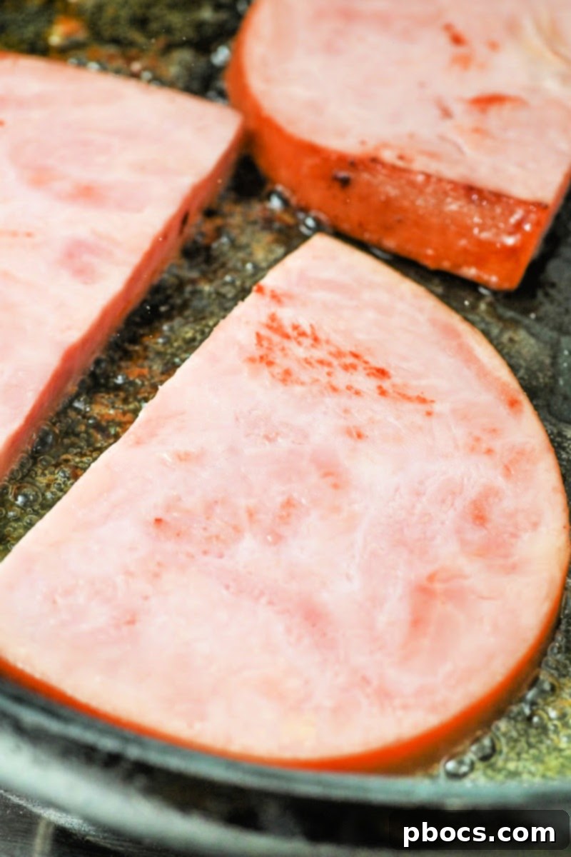 One-Pan Keto Honey-Glazed Ham and Green Beans 9 Frying ham steaks in a skillet for the keto recipe