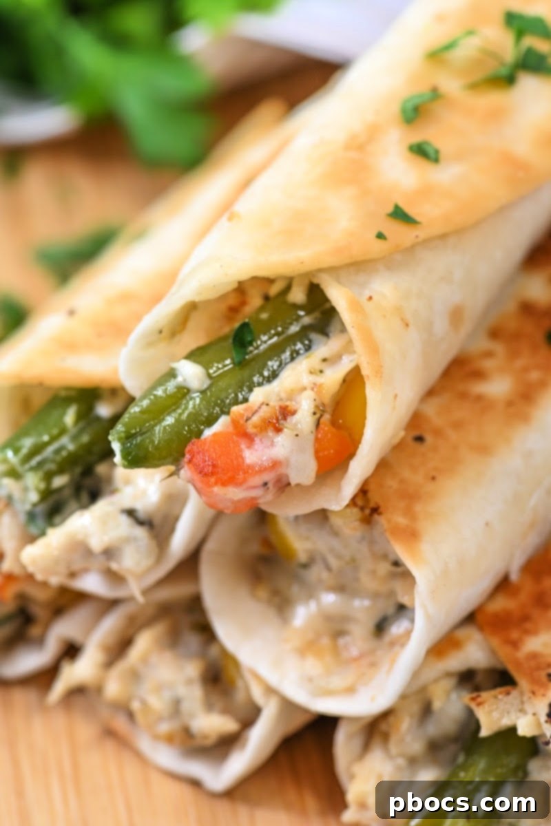 Delicious Low-Carb Crispy Chicken Pot Pie Roll-Ups arranged on a serving plate.
