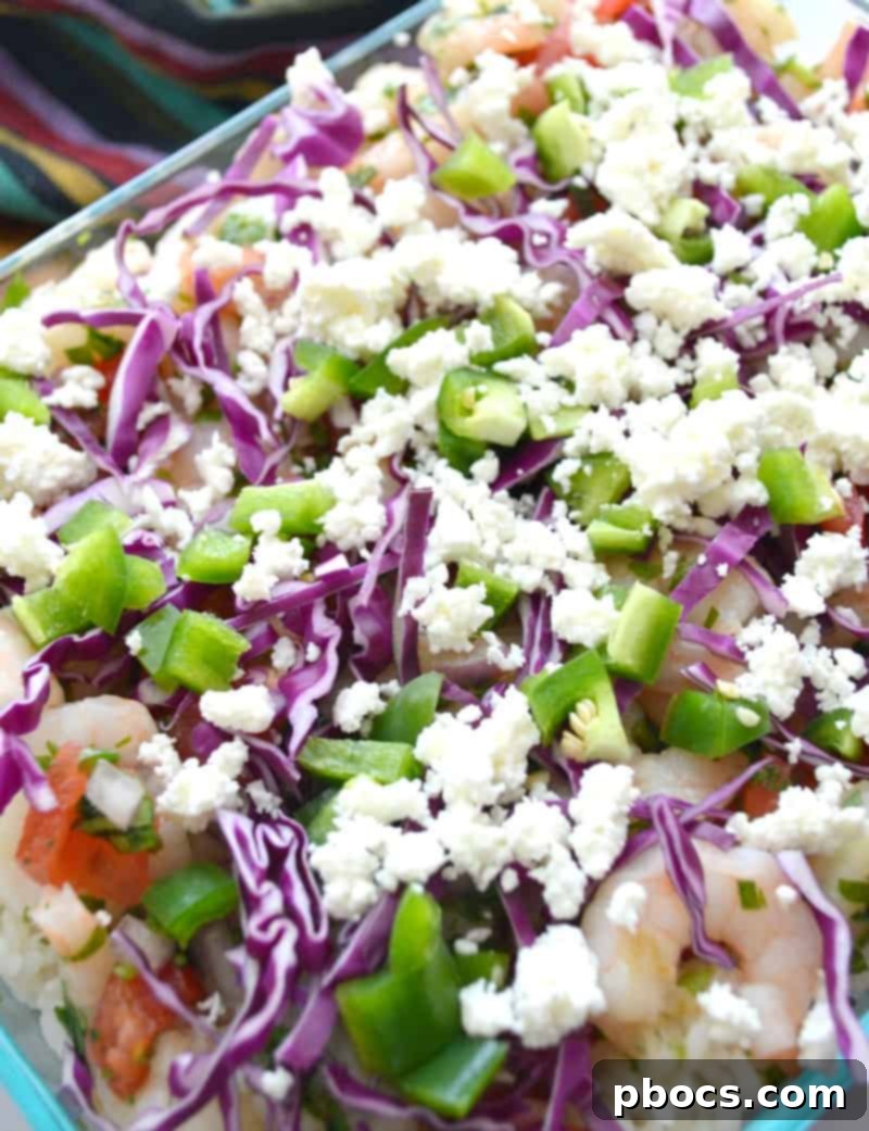 Beautifully layered Shrimp Ceviche Lasagna ready for toppings
