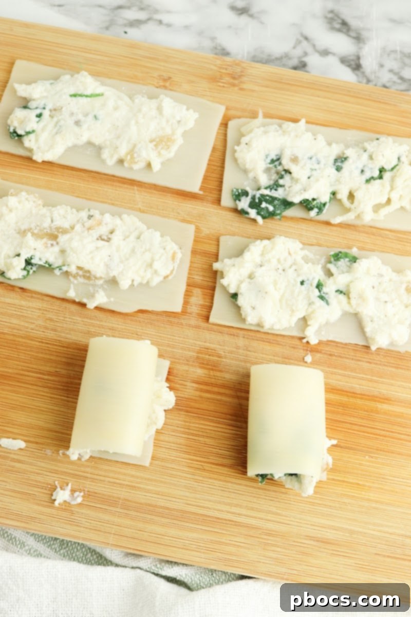 Creamy Keto Pumpkin Lasagna Spirals 12 Scooping filling onto Palmini lasagna sheets