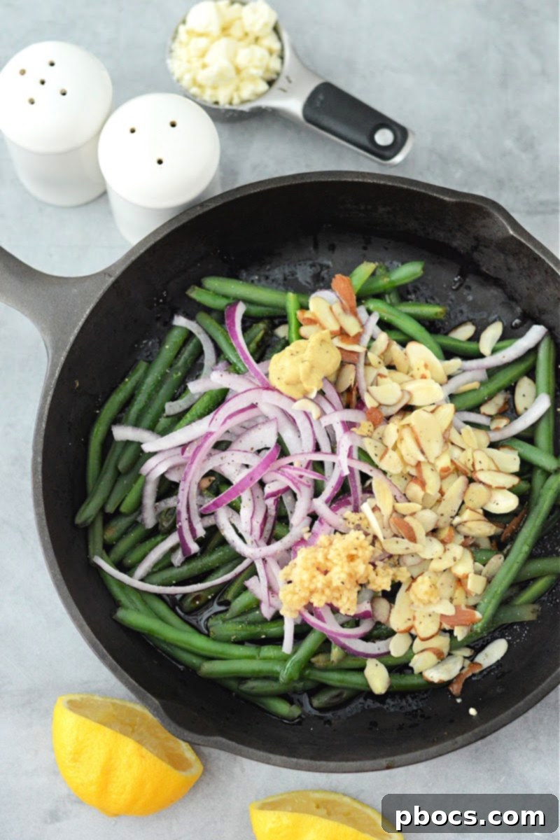 Warm Keto Green Bean Salad with Toasted Almonds 10 Adding onions, garlic, and almonds - to the skillet with green beans
