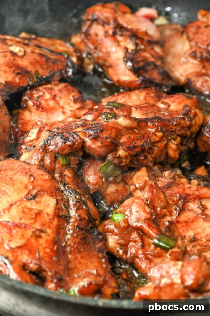 Seared chicken in a skillet, browning for flavor