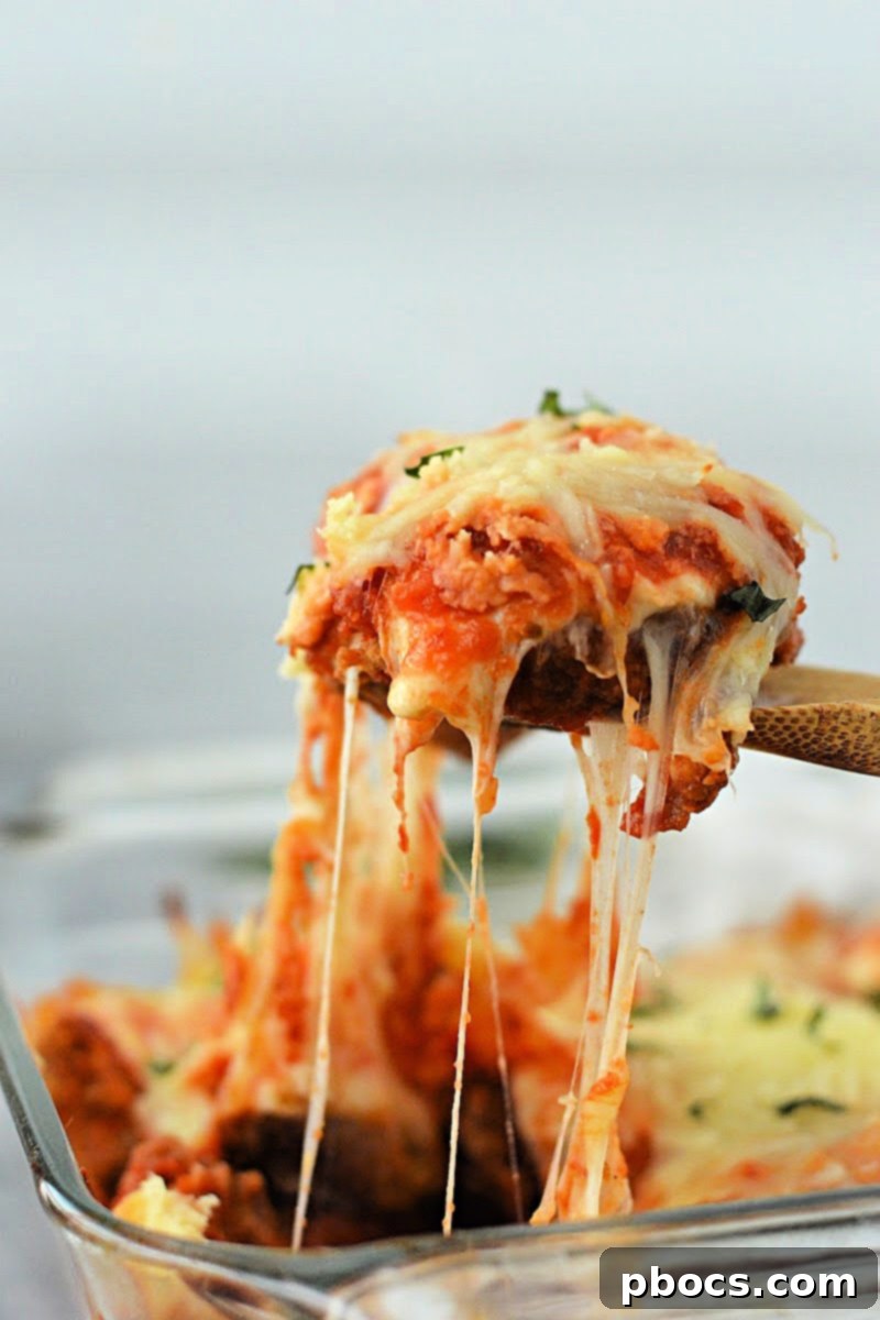 Keto Chicken Parmesan Nugget Bake 4 Layered ingredients for Keto Chicken Nugget Parmesan Casserole before baking