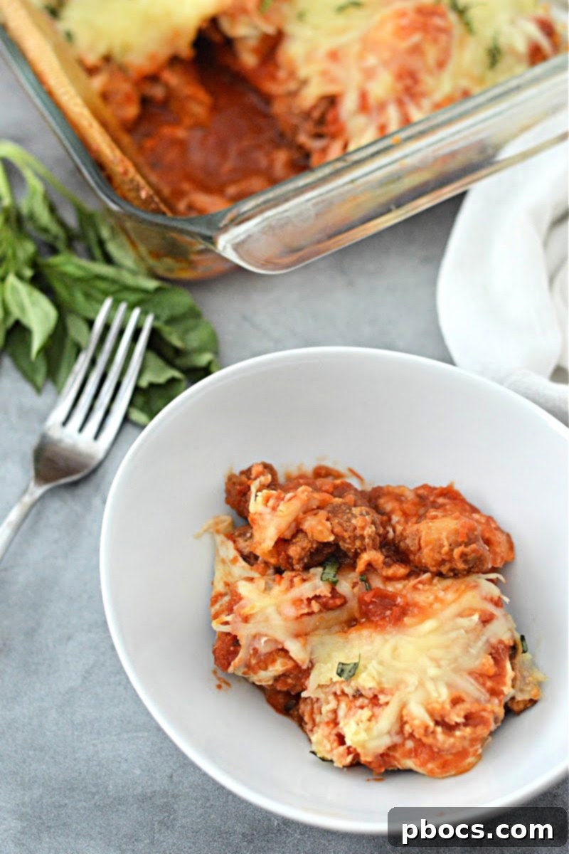 Keto Chicken Parmesan Nugget Bake 5 Fresh mozzarella cheese melting on Keto Chicken Nugget Parmesan Casserole