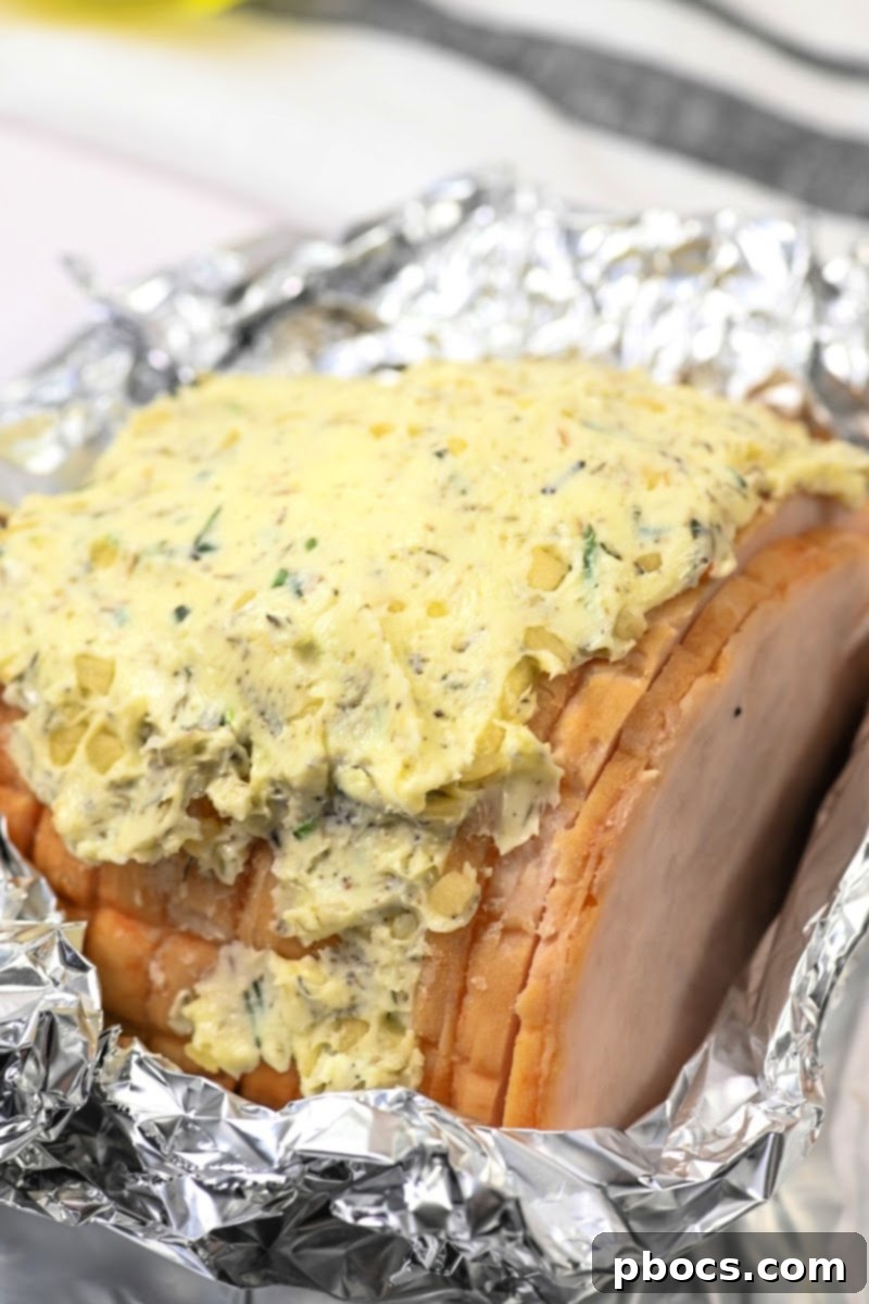 Sheet Pan Low-Carb Thanksgiving Feast 9 Rubbing herb butter onto turkey breast for roasting