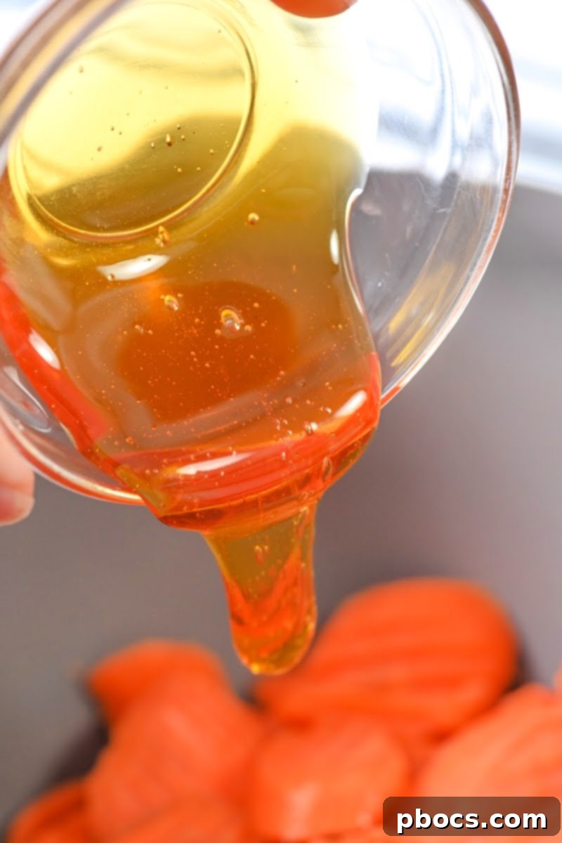Sheet Pan Low-Carb Thanksgiving Feast 10 Adding honey glaze to carrots on a sheet pan