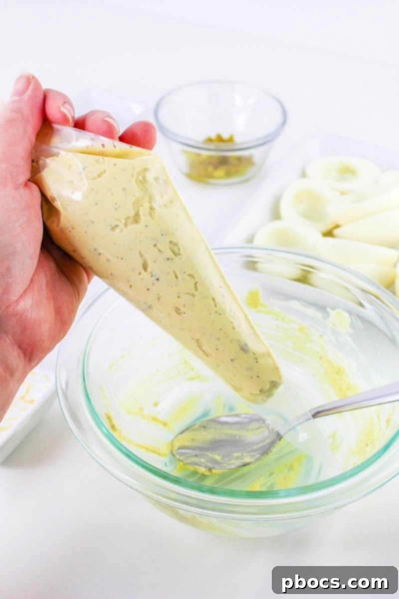 Filling a piping bag with deviled egg yolk mixture