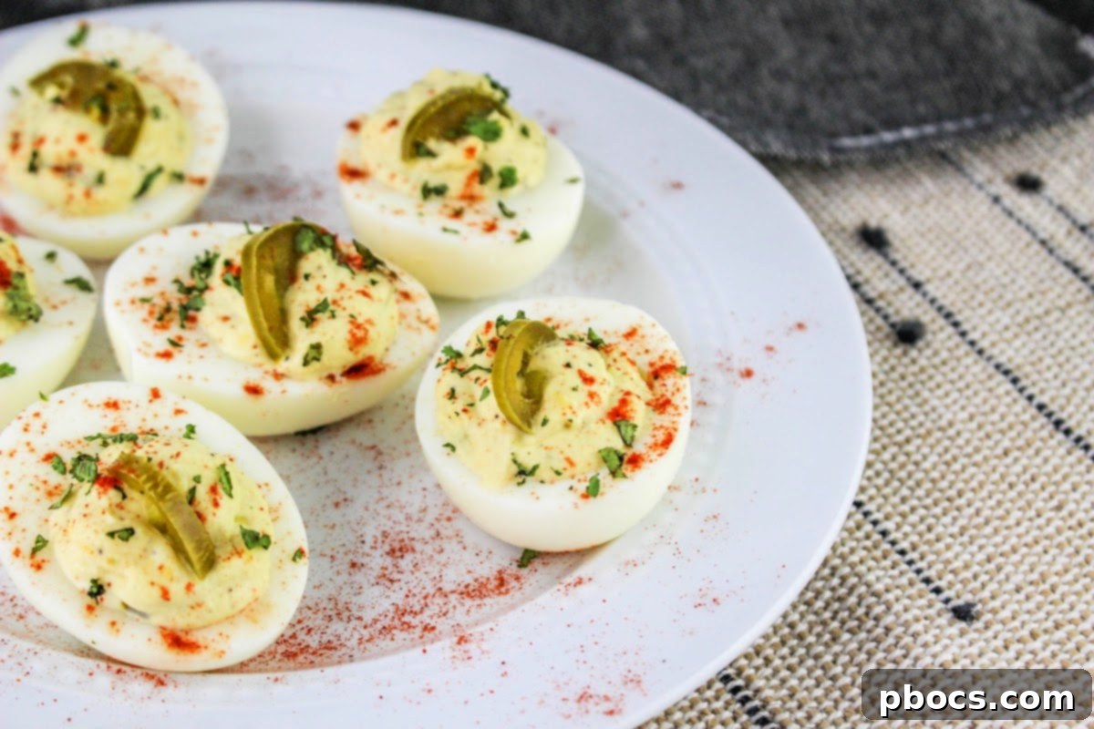 Garnishing Keto Jalapeno Deviled Eggs with paprika