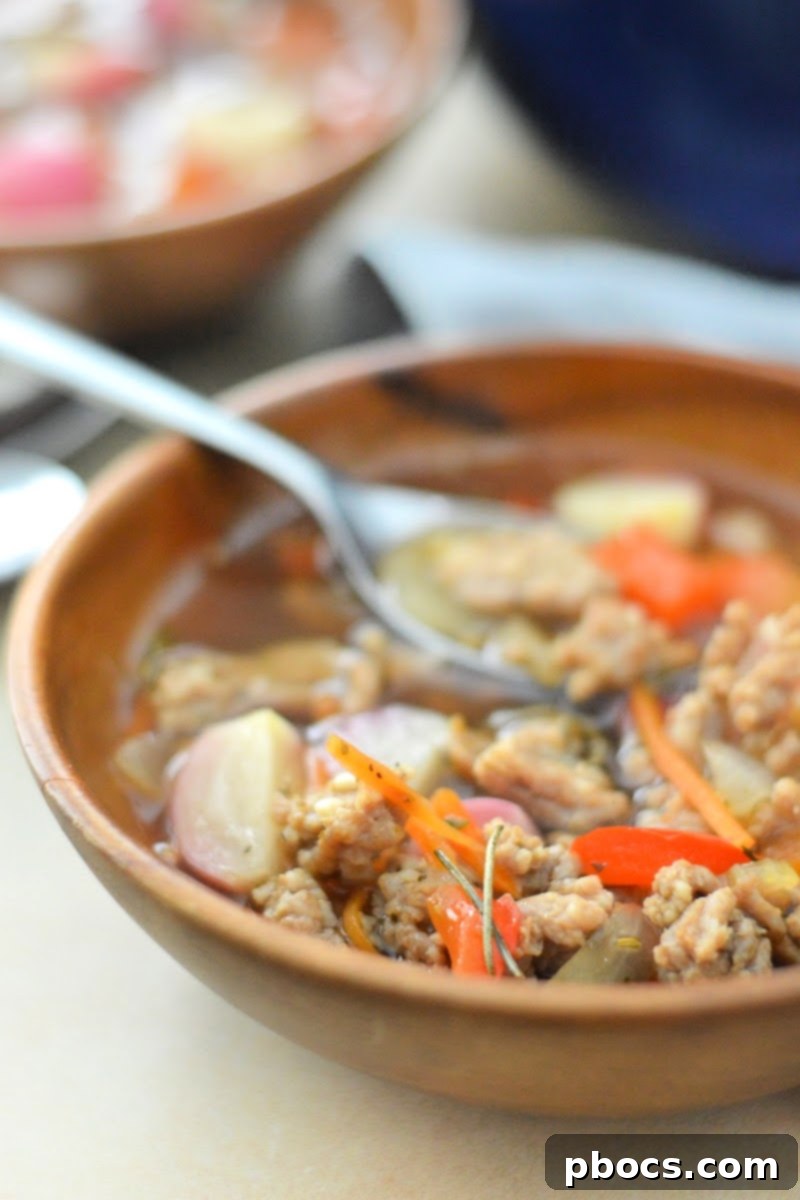 A bowl of Keto Sausage and Veggie Soup served with side dishes