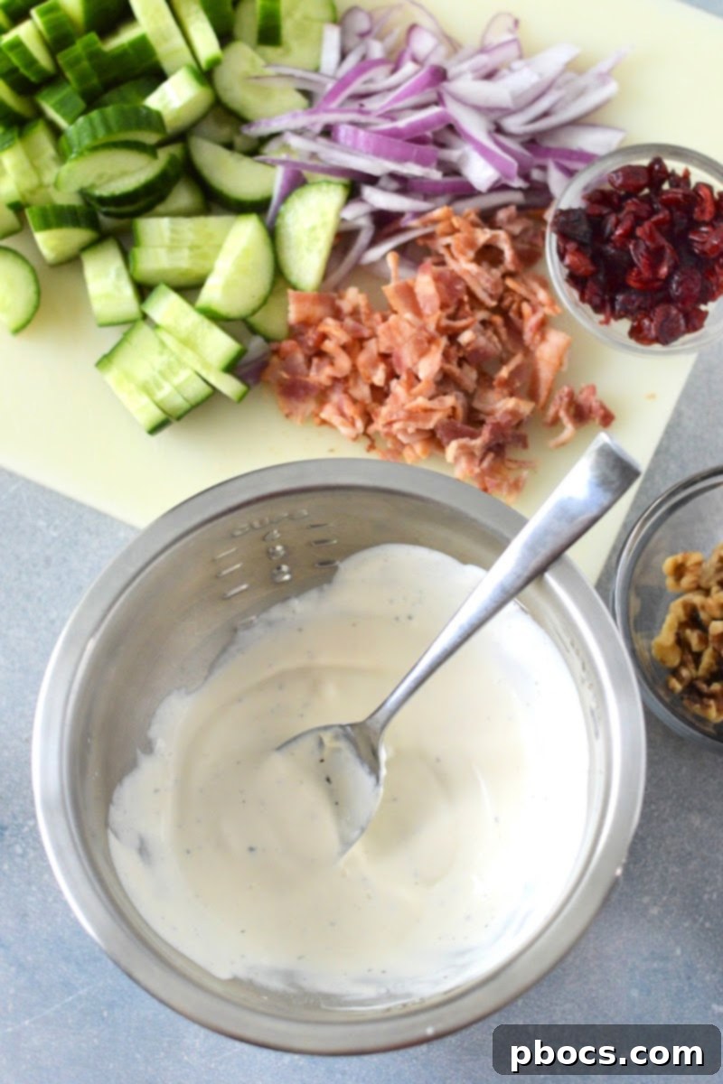 Keto Creamy Cucumber Salad With Cranberries - Whisking the Dressing