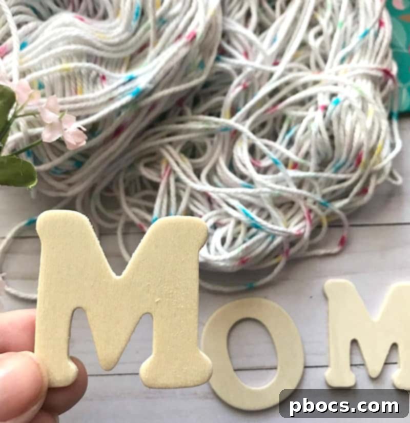 Starting to wrap yarn around a wooden letter for a DIY Mother's Day gift