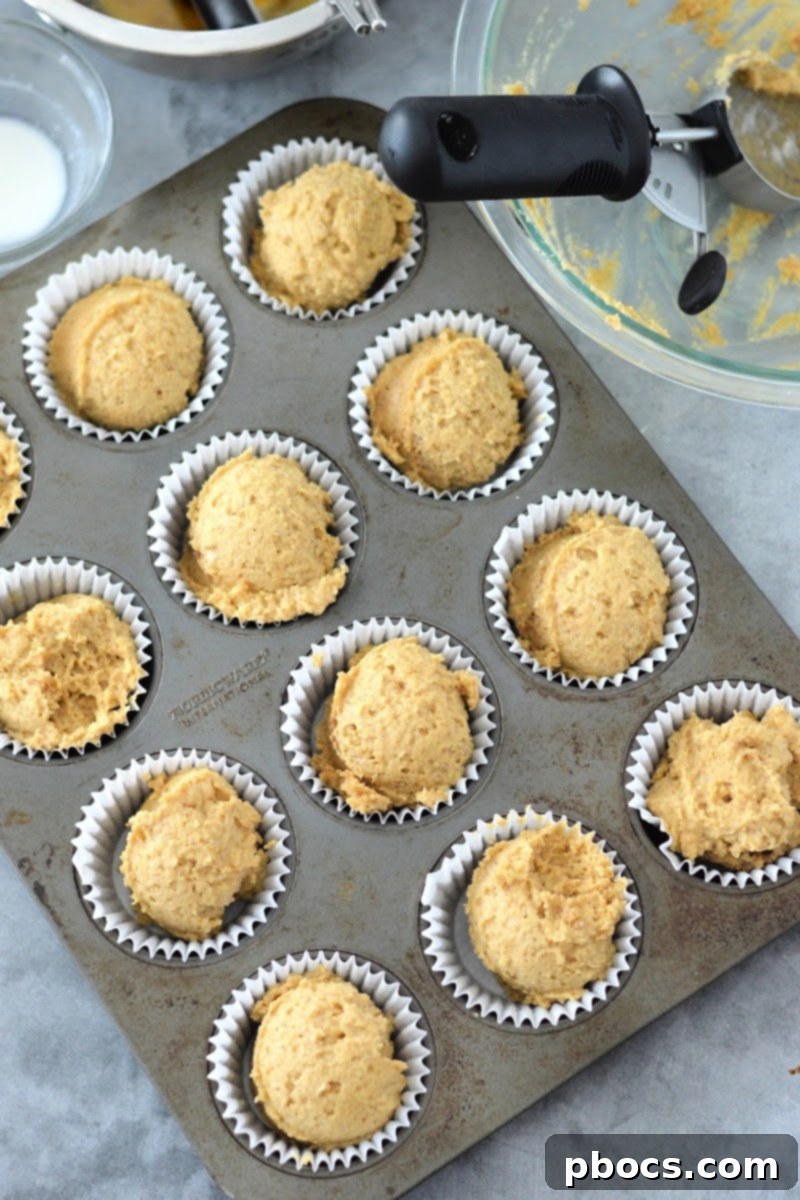 Spiced Keto Gingerbread Muffins with Creamy Icing 12 Keto gingerbread muffin batter in tin