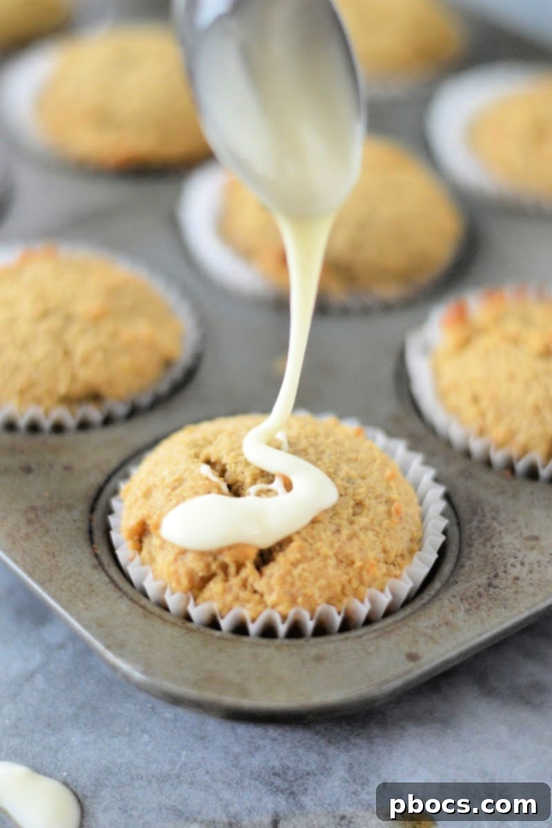 Spiced Keto Gingerbread Muffins with Creamy Icing 14 Drizzling eggnog glaze over cooled gingerbread muffins