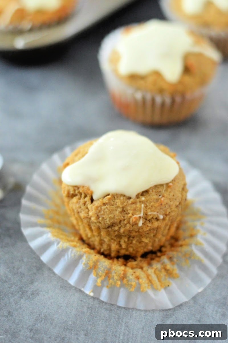 Spiced Keto Gingerbread Muffins with Creamy Icing 4 Pouring Keto Eggnog Icing on Gingerbread Muffins