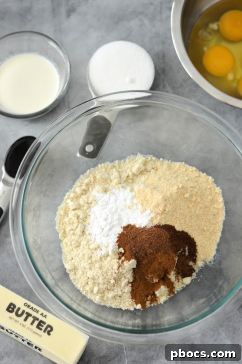 Spiced Keto Gingerbread Muffins with Creamy Icing 9 Mixing dry spices with flours for gingerbread muffins