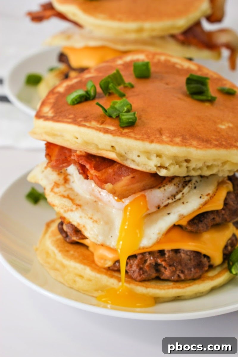 Smashburger patties cooking on a hot skillet