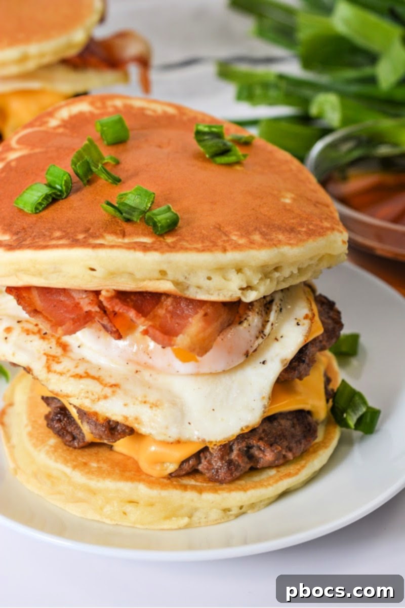 Assembling a Keto Pancake Breakfast Smashburger with a fried egg