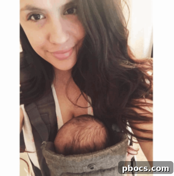 My Babywearing Love Story and Top Carriers 2 A mother comfortably wearing her baby in a carrier while working or doing daily tasks.