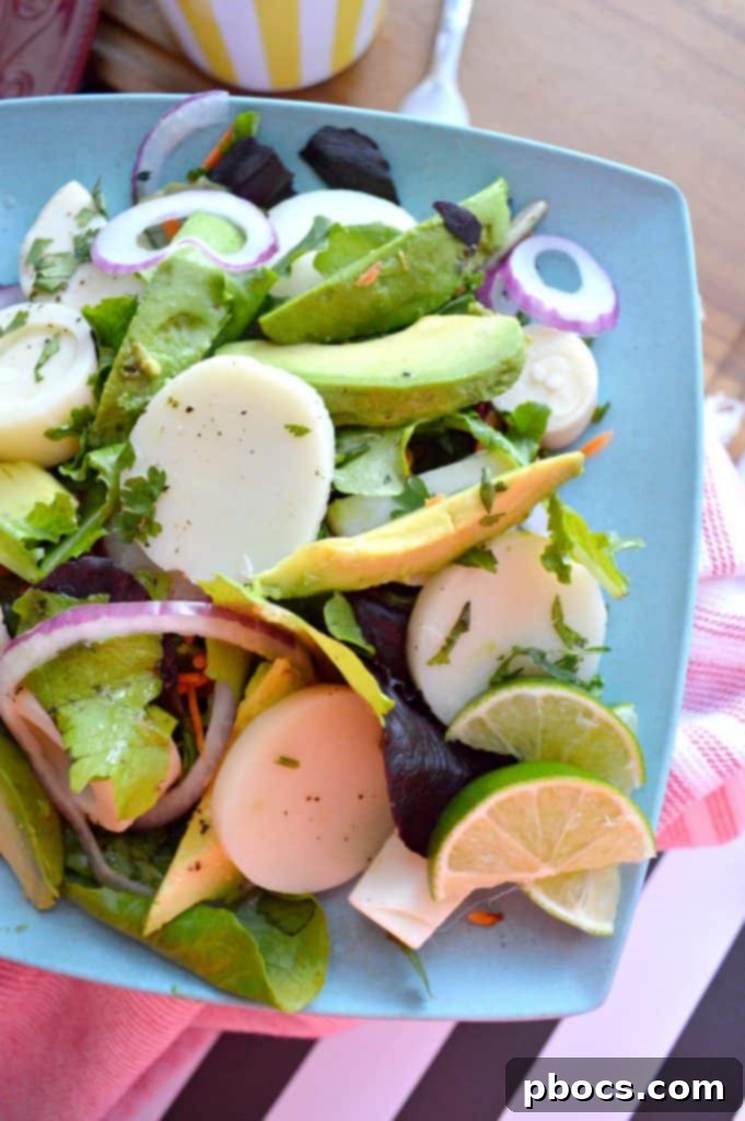 Vibrant Hearts of Palm, Red Onion & Avocado Salad in a large serving bowl