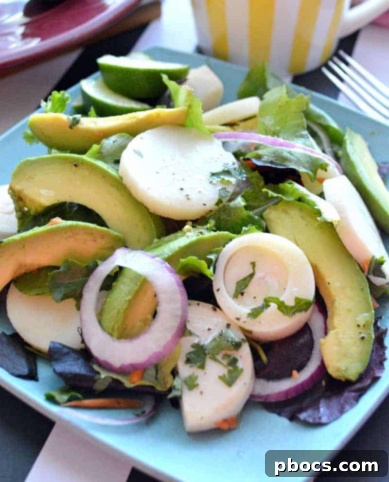 Overhead view of a prepared Hearts of Palm, Red Onion & Avocado Salad, ready to serve