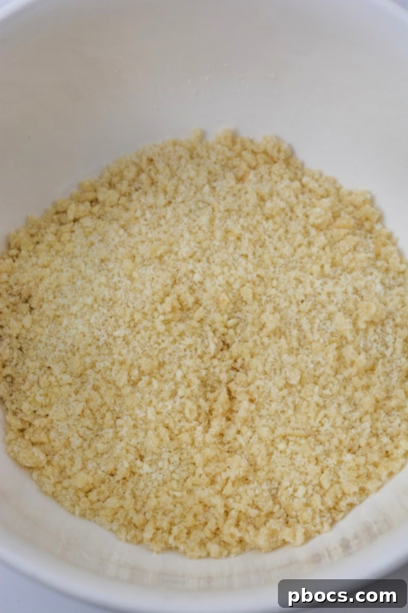 Preparing the crispy pork rind and Parmesan topping