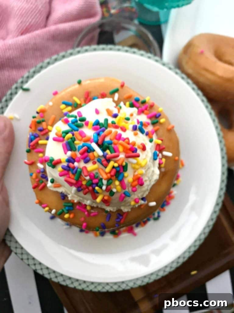 The Final Layer of Ice Cream and Toppings on Donut Cake
