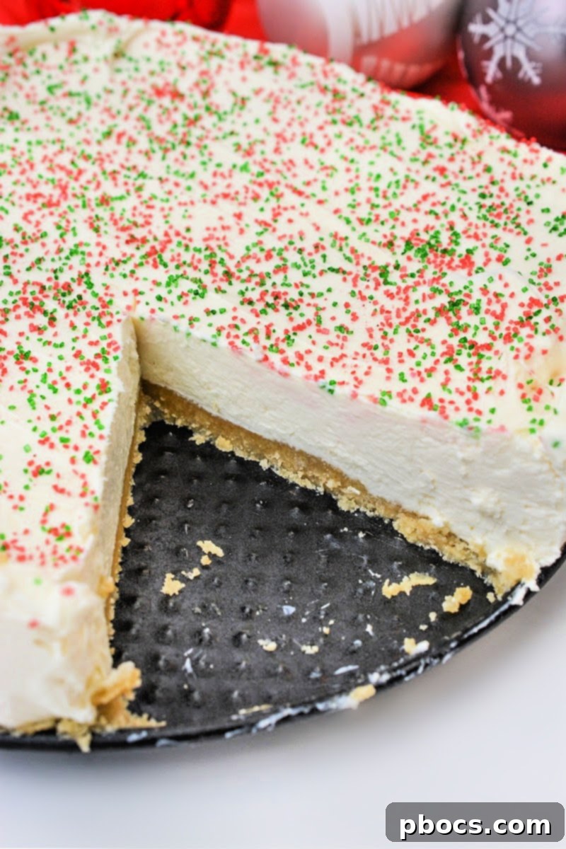 Decorated Low Carb Christmas Cookie Cheesecake with vibrant sprinkles