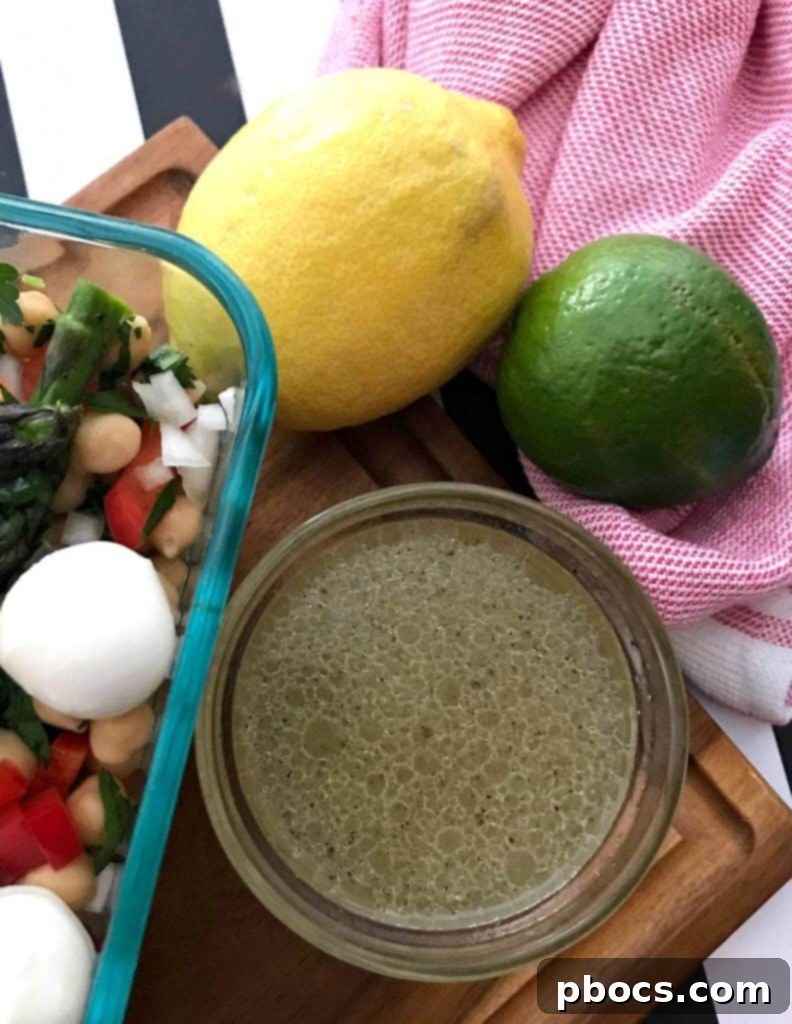 Cooked asparagus being added to the salad bowl.