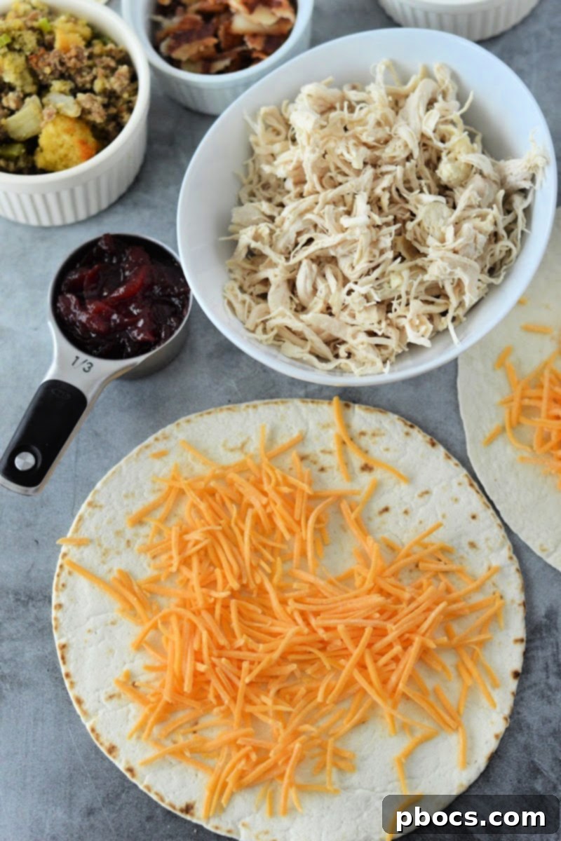 Festive Keto Crunchwrap Delight 9 Spreading cheddar cheese evenly on a large keto tortilla as the first step for the crunchwrap.