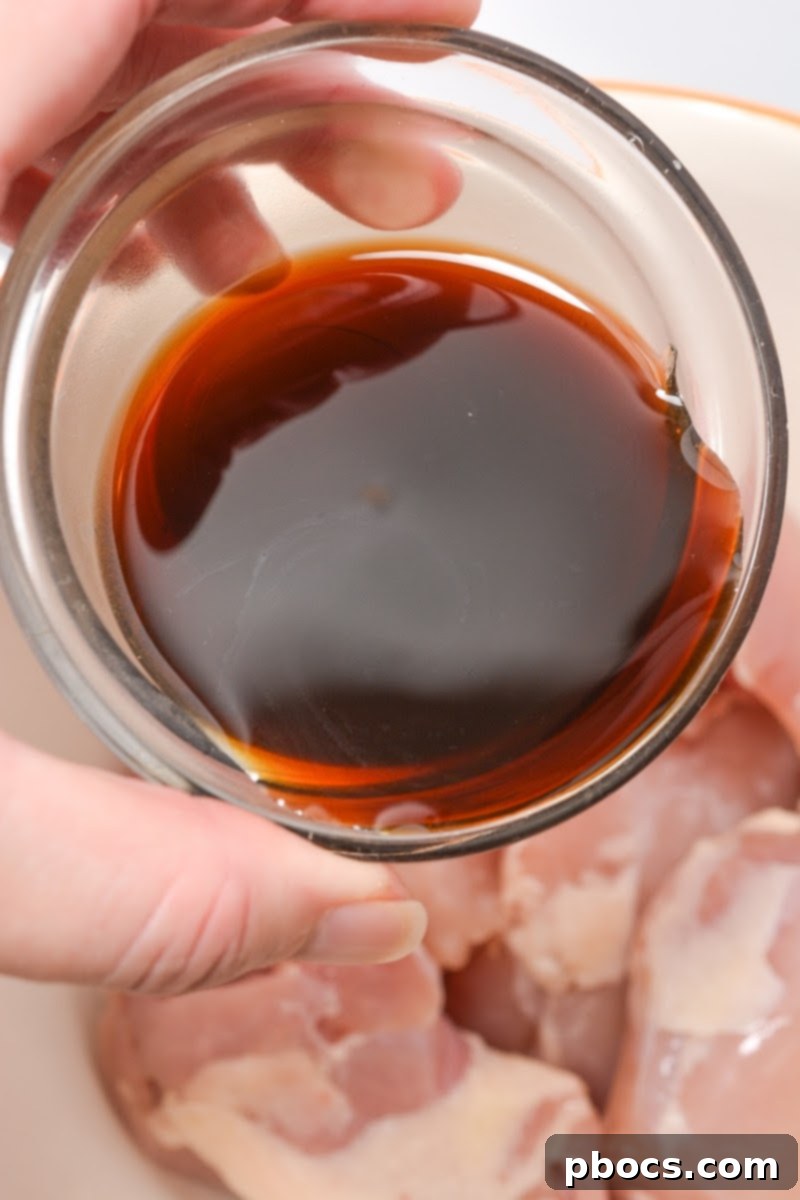 One-Pan Low-Carb Crack Chicken with Green Beans 9 Massaging marinade into boneless chicken thighs