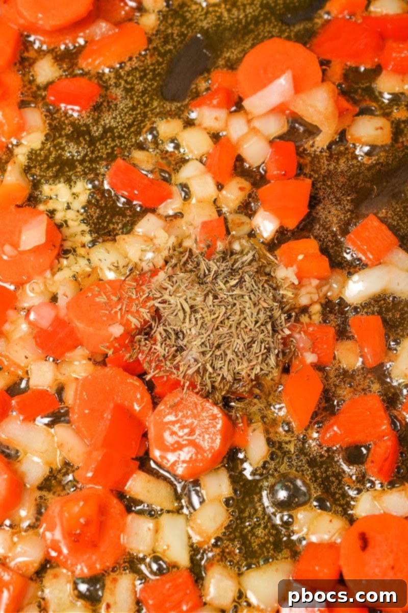 Minced garlic and dried thyme added to sautéed vegetables