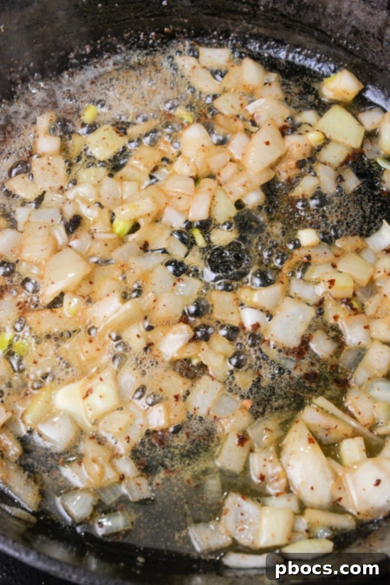 Sweet and Sticky Low-Carb Honey Garlic Shrimp and Sausage 10 Cooking diced onions